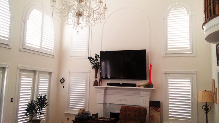 Atlanta great room with wall-mounted television and arched windows.